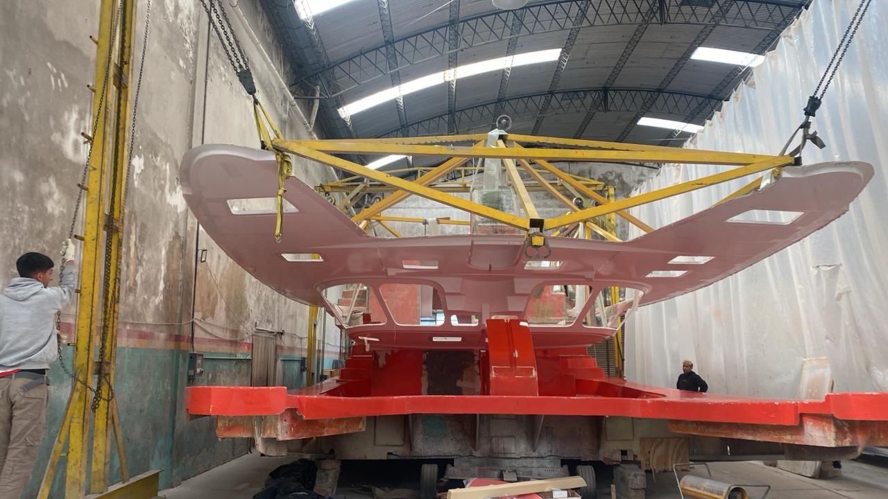 Catamaran deck being lifted into position by overhead crane