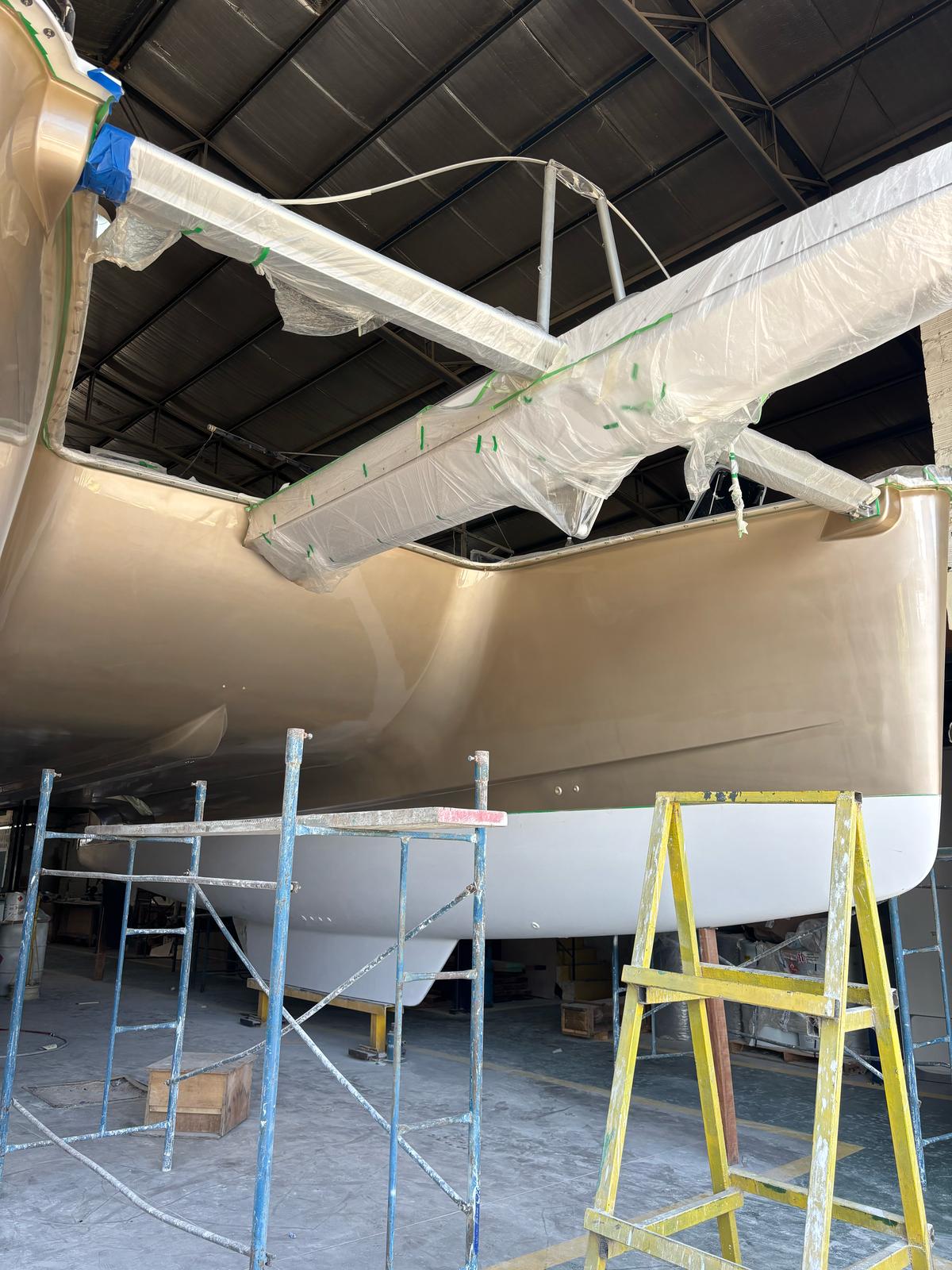 Freshly painted catamaran hull with flawless gelcoat finish
